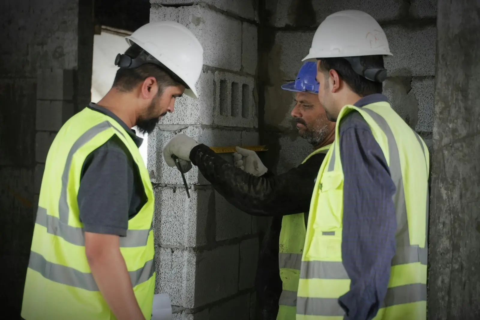 Construction workers in safety gear on a building site